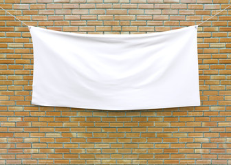 Obraz premium Cloth banner hanging on brick wall. 3D illustration