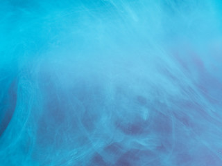 Fototapeta na wymiar Abstract colored background. Blue smoke, ink in water, the patterns of the universe. Abstract movement, frozen multicolor flow of paint. Horizontal photo with soft focus, blurred backdrop.