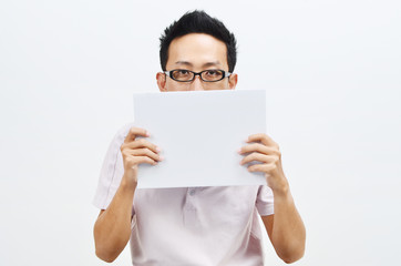 Asian man holding white paper card covering face