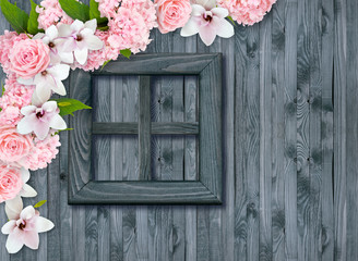 Fototapeta na wymiar Roses, hortensia and magnolia flowers on background of shabby wooden wall and window