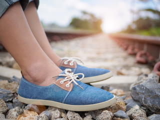 Closeup woman sitting on the railway platform. Travel and vacation concept.