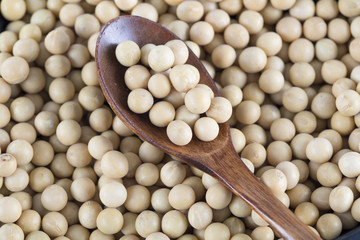 Soy beans and wooden spoon.