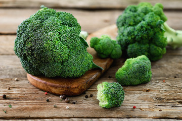 Fresh organic broccoli on wooden table close up