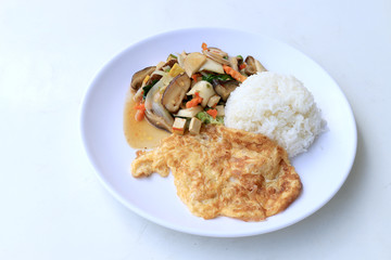 Stir Fried Tofu in Chinese Style,Stir fried tofu with mixed vegetables and fried egg in white plate with rice on white background for celebrate Chinese new year festival,Vegetarian Food, healthy food.