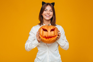 Cheerful young woman dressed in crazy cat halloween costume
