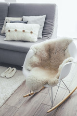 Rocket chair with sheep skin rug in scandinavian living room