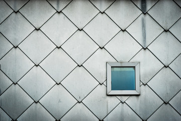 wall of a modern building with one square window