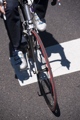 Сyclist on the road bike crosses the street at pedestrian crossing