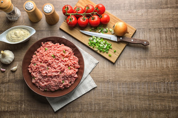 Composition with fresh raw minced meat on table