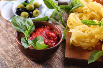 Bowl with tasty tomato sauce for pasta on table