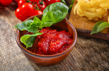 Bowl with tasty tomato sauce for pasta on table