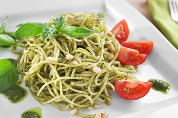 Delicious pasta with pesto sauce on plate, closeup