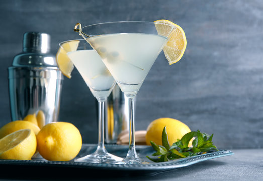 Glasses of lemon drop martini with olives on metal tray