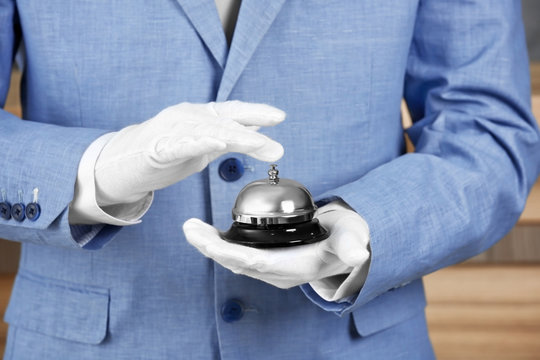 Man with bell on blurred background, closeup