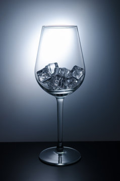 Wine glass filled with ice cubes