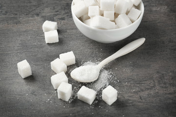 Refined white sugar on grey table