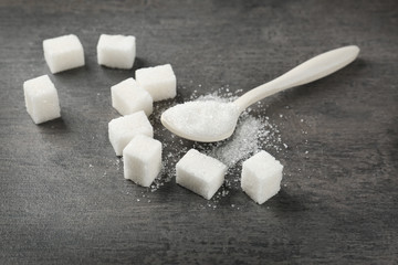 Refined white sugar on grey table