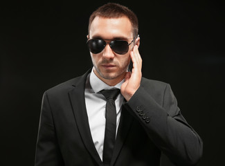 Handsome security guard on dark background