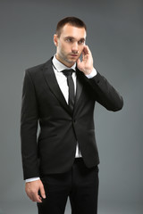 Handsome security guard on grey background