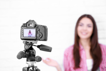 Young woman recording video at home