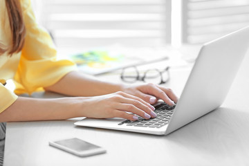 Young woman working on laptop at home