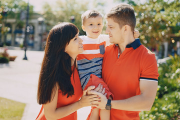 beautiful family in red walking down the street and the Park