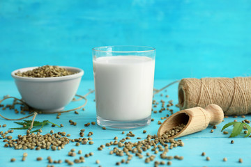 Glass of hemp milk on wooden table