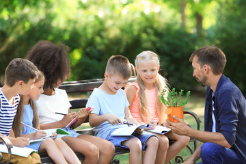 Group of children with teacher in park