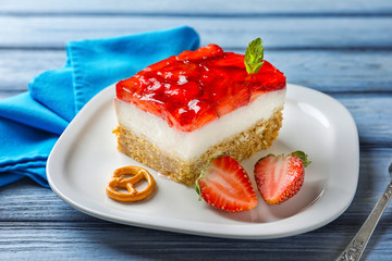 Plate with strawberry pretzel salad on table