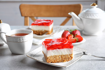 Plate with strawberry pretzel salad on table