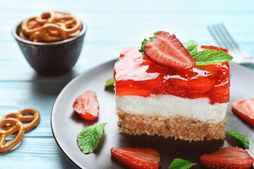 Plate with delicious strawberry pretzel salad on table, close up