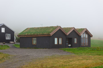 Fototapeta na wymiar Rural Icelandic cottage at foggy day