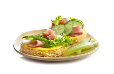 Plate of tasty sandwiches with fresh cucumber on white background