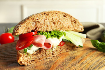 Tasty sandwich with fresh cucumber on table, close up