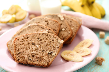Fototapeta premium Sliced banana bread with nuts on plate