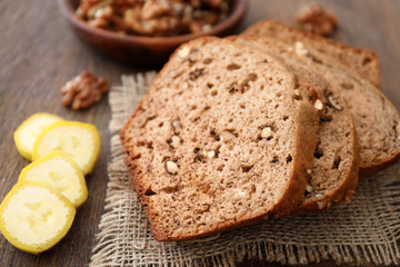 Sliced banana bread with nuts on table