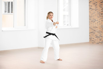 Fototapeta na wymiar Female karate instructor training in dojo