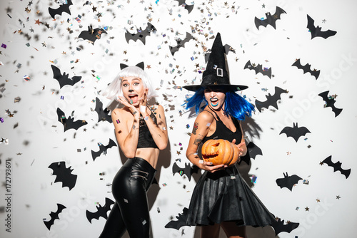 Two happy young women in leather halloween costumes