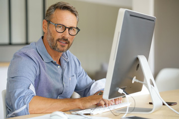 Businessman working on desktop computer
