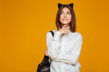 Fototapeta premium Young teenage schoolgirl in uniform with backpack