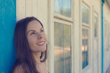 Portrait of a young woman next to a blue wooden background