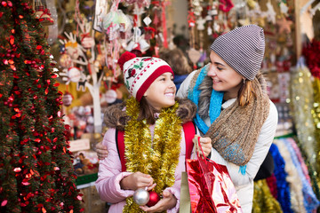 Girl with mom buying decorations