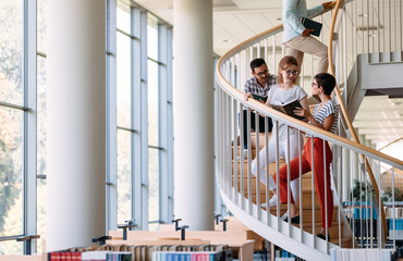 Group of students discussing in university library
