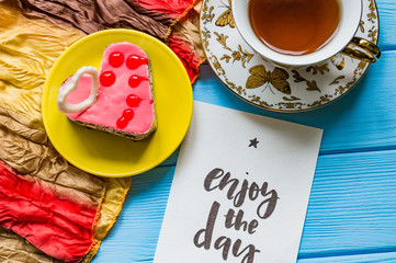 Still life with cup of tea on the wooden background
