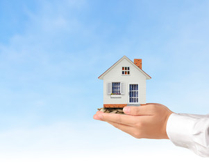 salesman person giving to buyer customer,house in hand