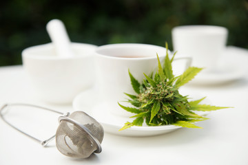 Cunnabis on cup of tea and tea strainer