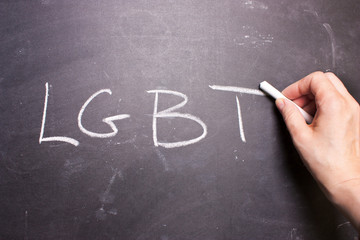 word LGBT is written chalk on the blackboard