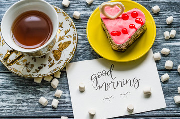 Still life with cup of tea on the wooden background