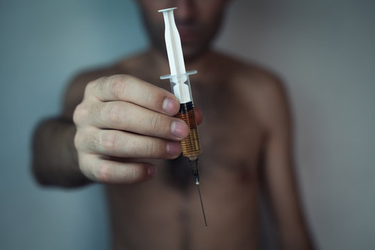Drug addict with a syringe.