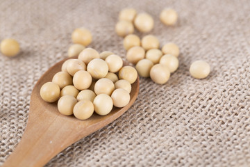 Soy beans and wooden spoon.